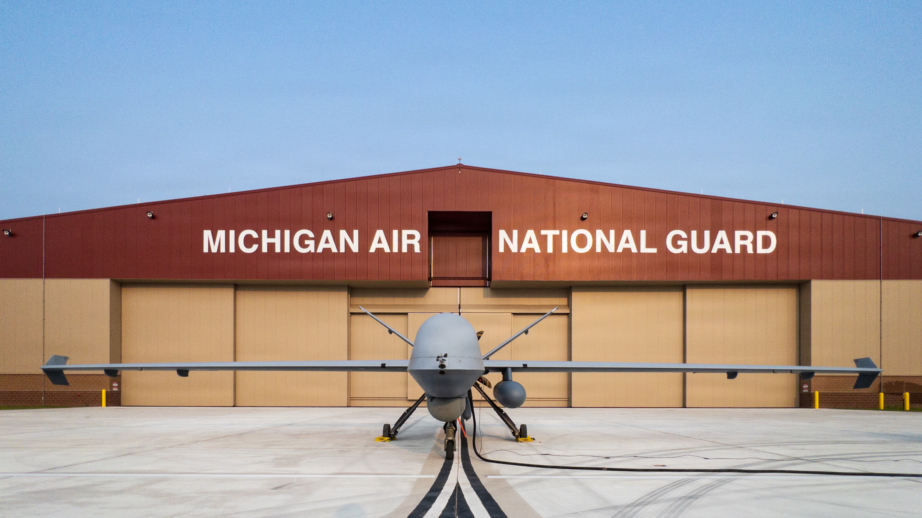 An MQ-9 Reaper from Holloman Air Force Base, New Mexico is parked outside the Michigan Air National Guard hangar at the Alplena Combat Readiness Training Center, Michigan.